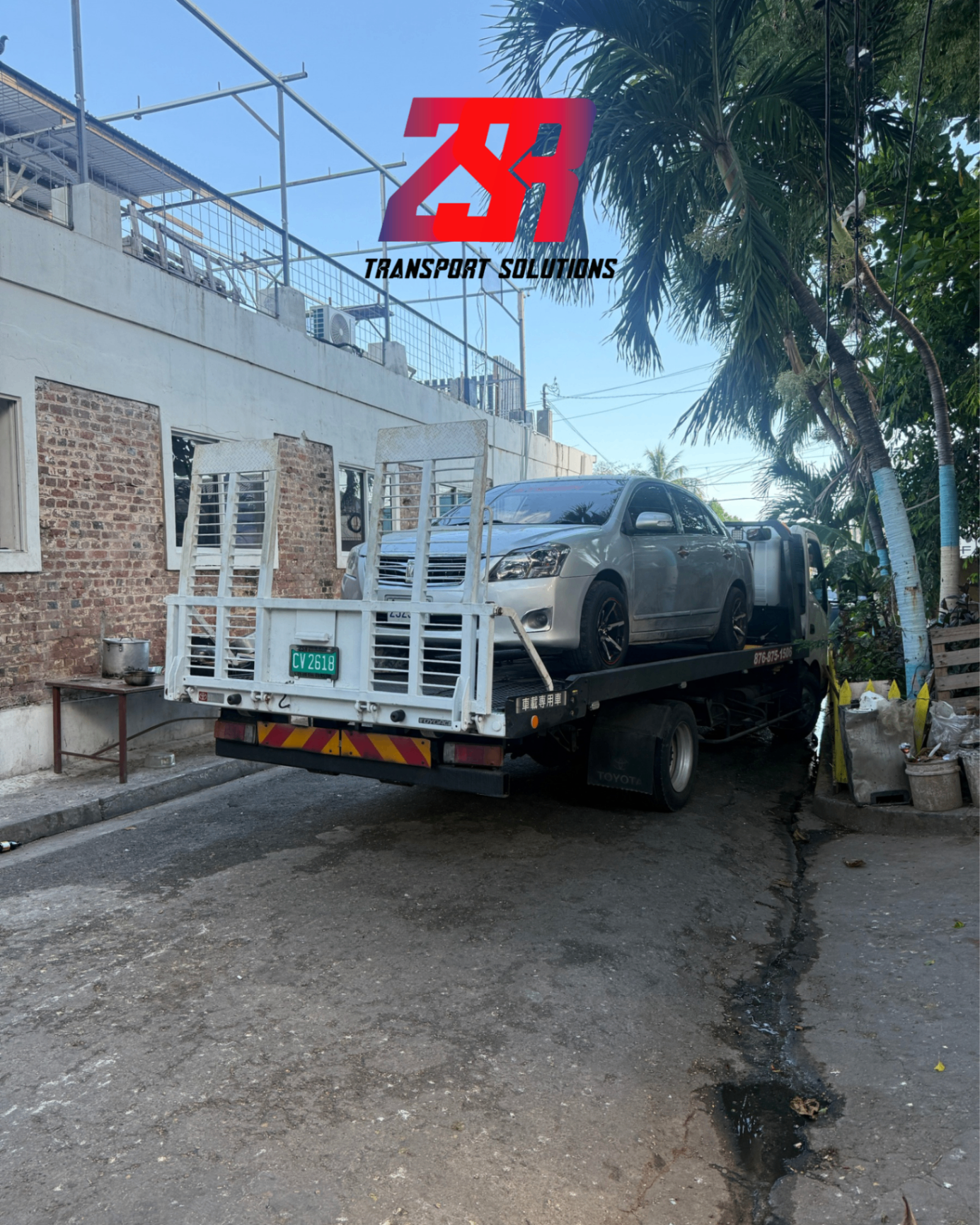 ZSR flatbed wrecker towing a vehicle in Jamaica